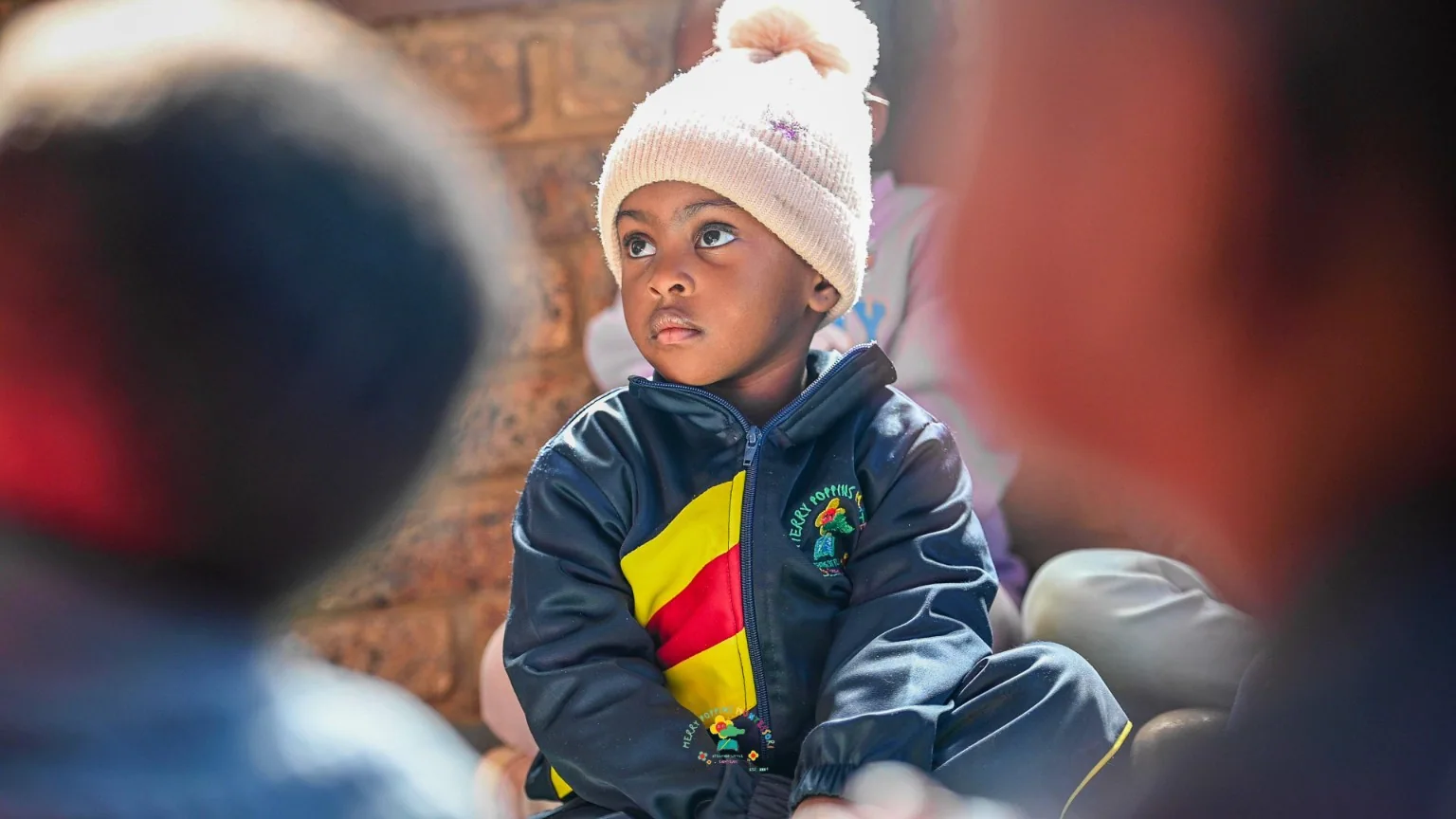 Children listening together during a classroom activity